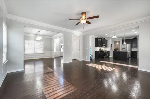 a view of a livingroom with a kitchen and wooden floor