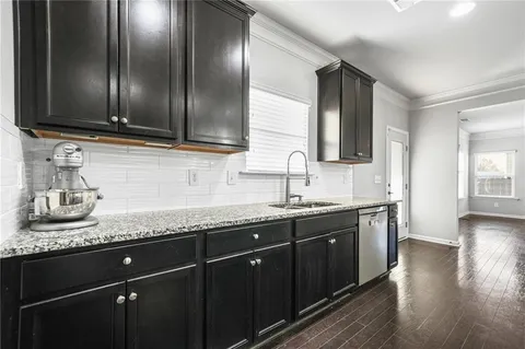 a kitchen with granite countertop stainless steel appliances and sink