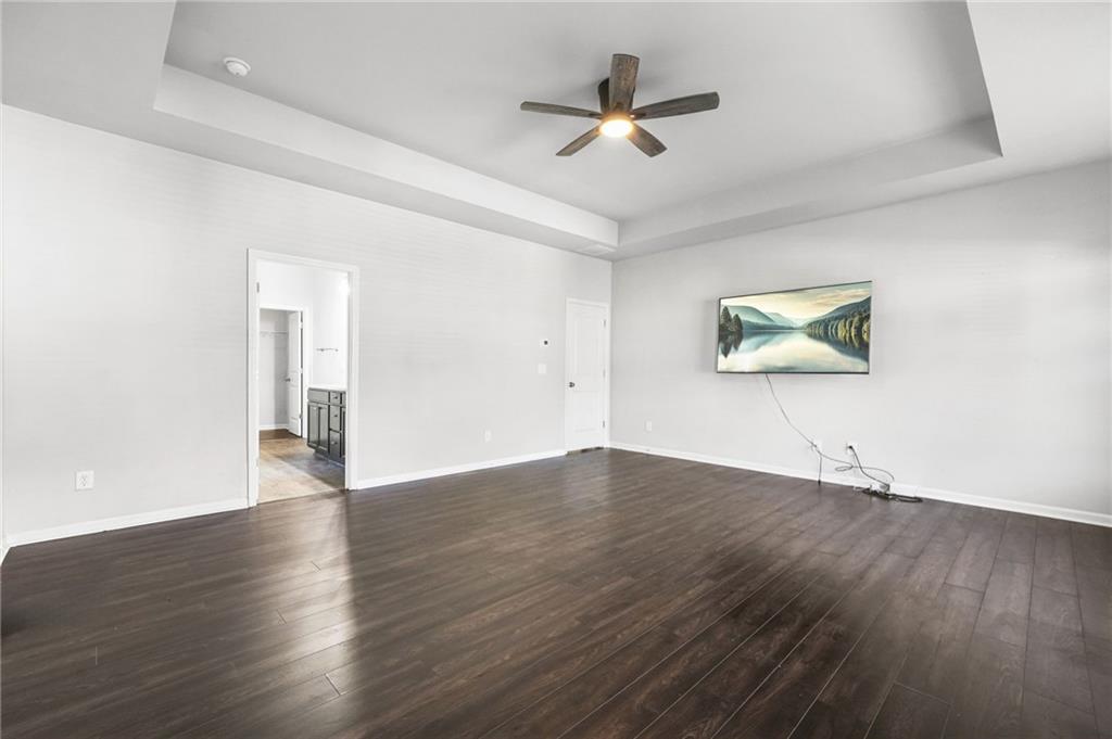 200 Cherokee Reserve Circle Canton, GA 30115 - Photo 28 of 50 a view of an empty room with wooden floor and a ceiling fan