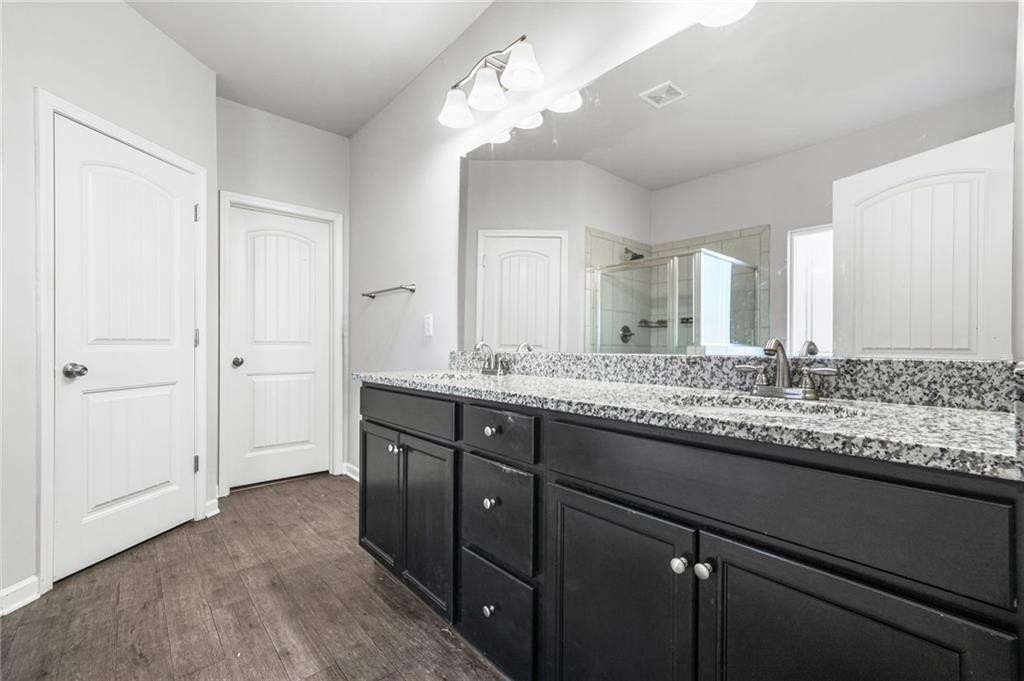 200 Cherokee Reserve Circle Canton, GA 30115 - Photo 30 of 50 a bathroom with a granite countertop sink and a mirror