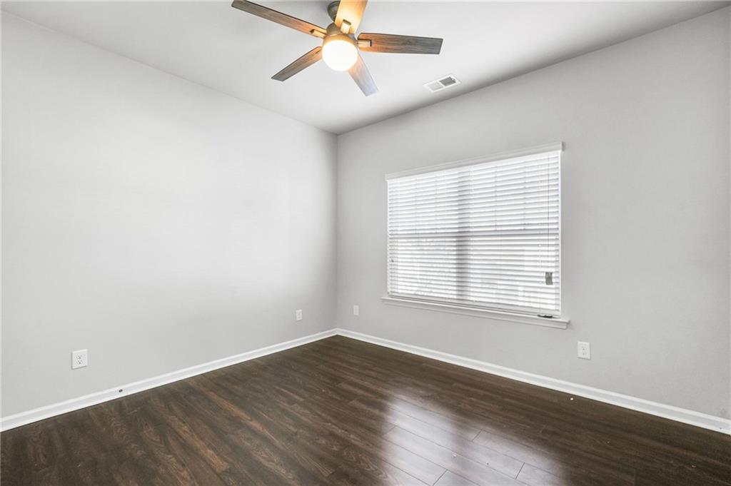 200 Cherokee Reserve Circle Canton, GA 30115 - Photo 37 of 50 an empty room with wooden floor fan and windows
