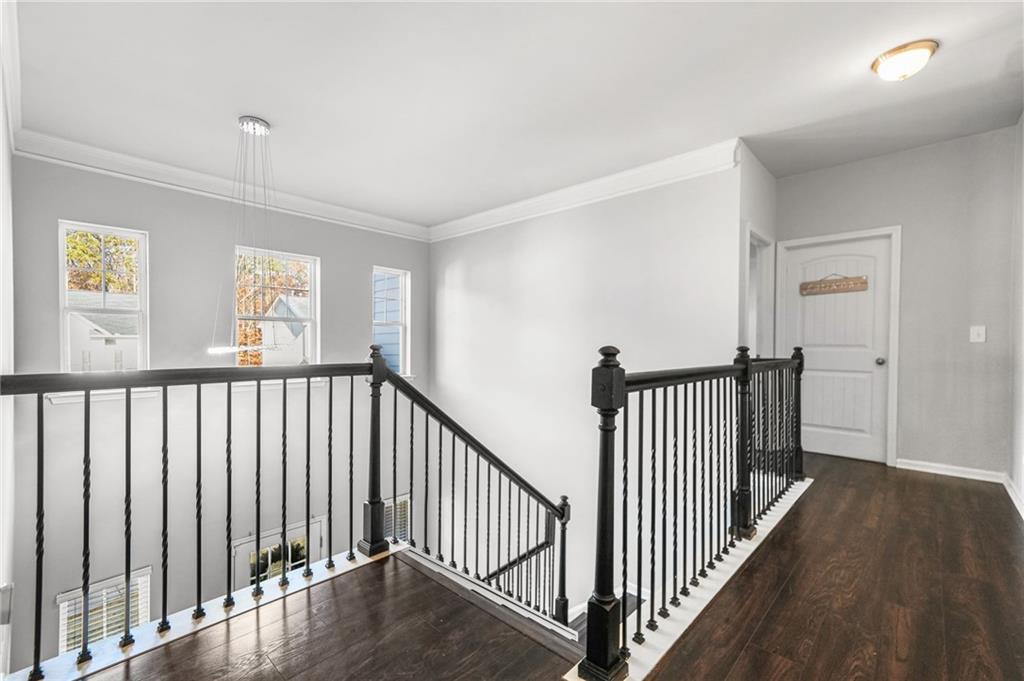 200 Cherokee Reserve Circle Canton, GA 30115 - Photo 43 of 50 a view of a hallway with wooden floor and stairs