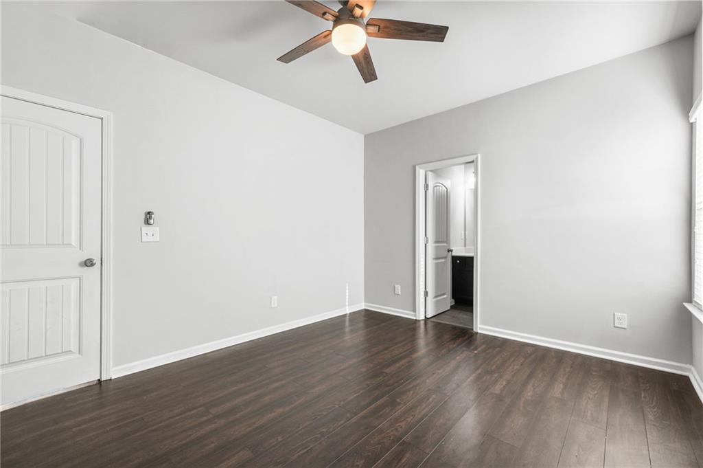 200 Cherokee Reserve Circle Canton, GA 30115 - Photo 45 of 50 a view of an empty room with wooden floor and a ceiling fan