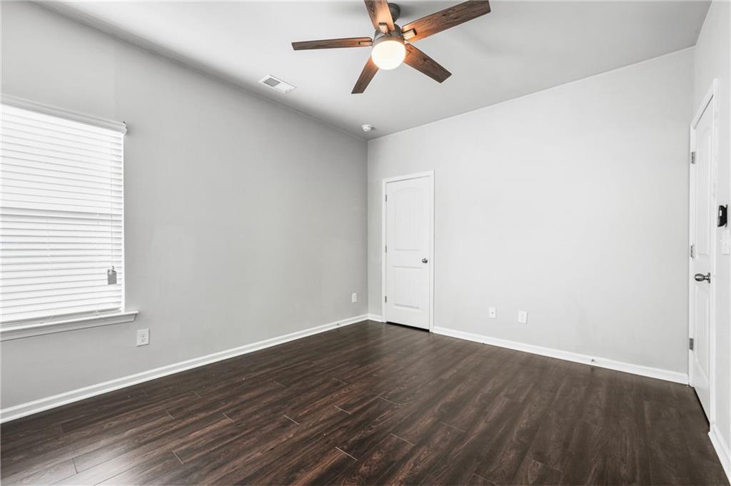 200 Cherokee Reserve Circle Canton, GA 30115 - Photo 46 of 50 an empty room with wooden floor fan and windows