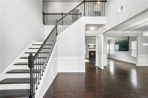 a view of entryway and hall with wooden floor