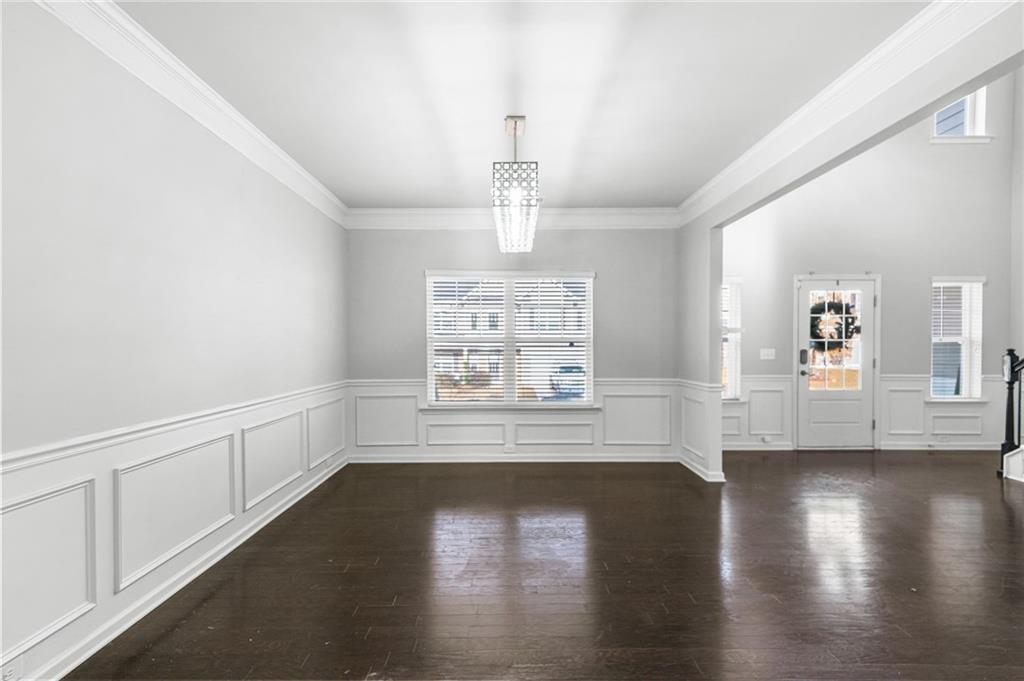 200 Cherokee Reserve Circle Canton, GA 30115 - Photo 6 of 50 a view of an empty room with wooden floor and a window