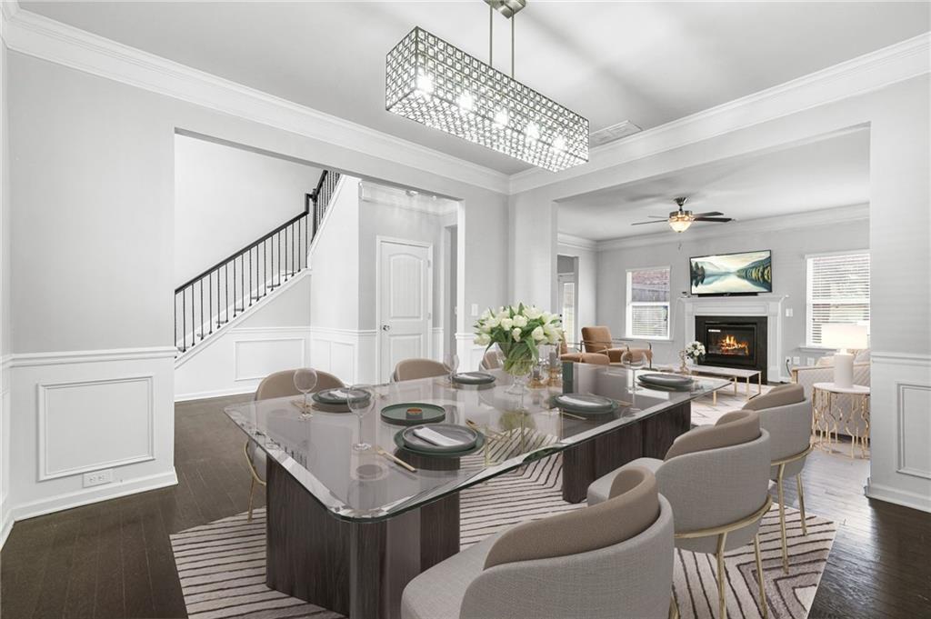 200 Cherokee Reserve Circle Canton, GA 30115 - Photo 7 of 50 a dining room with furniture a chandelier and wooden floor