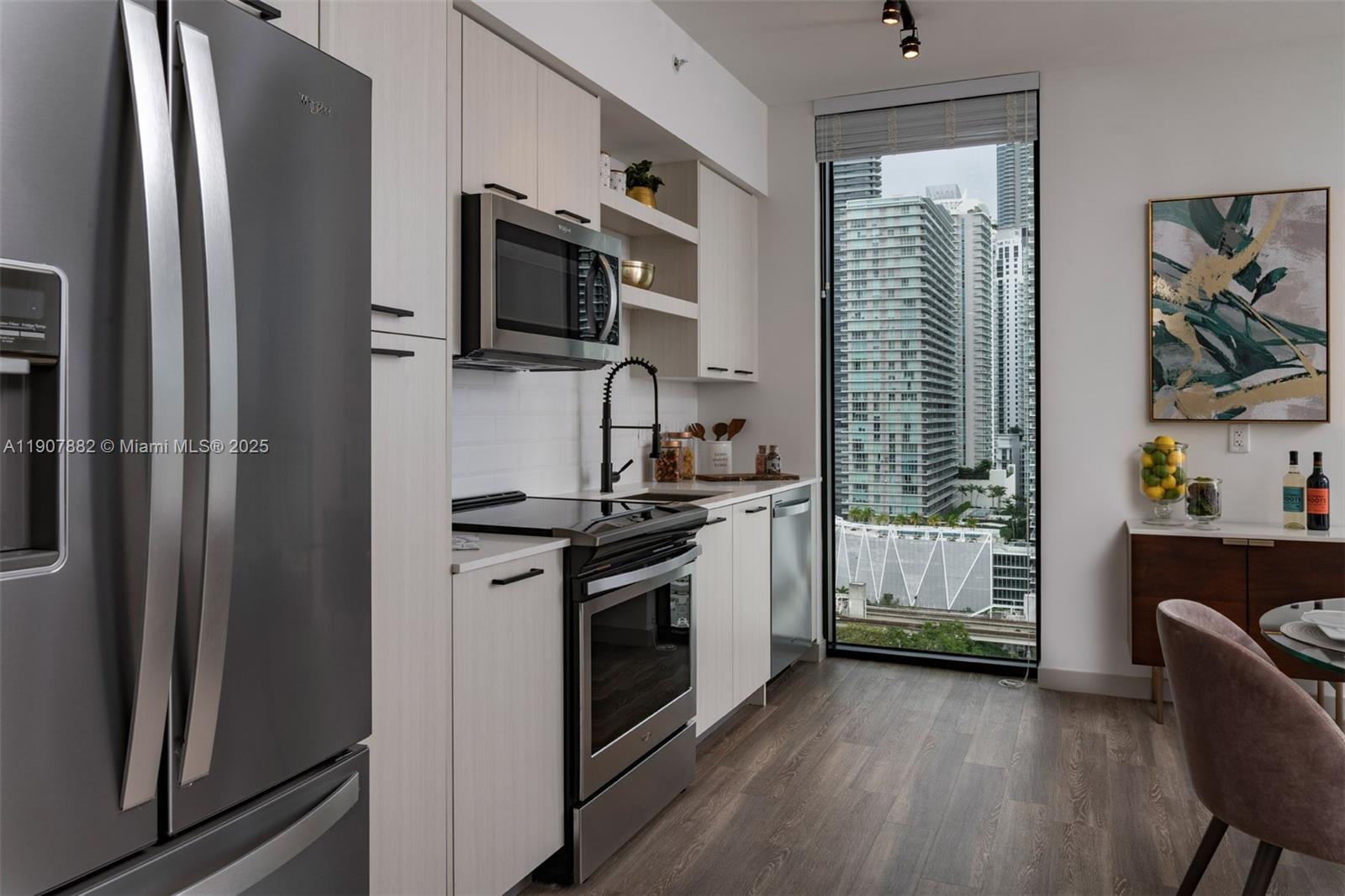 221 Southwest 12th Street, Unit 416 Miami, FL 33130 - Photo 13 of 31 a kitchen with stainless steel appliances granite countertop a refrigerator a stove a sink and a microwave