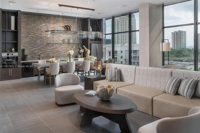 a living room with furniture and a floor to ceiling window