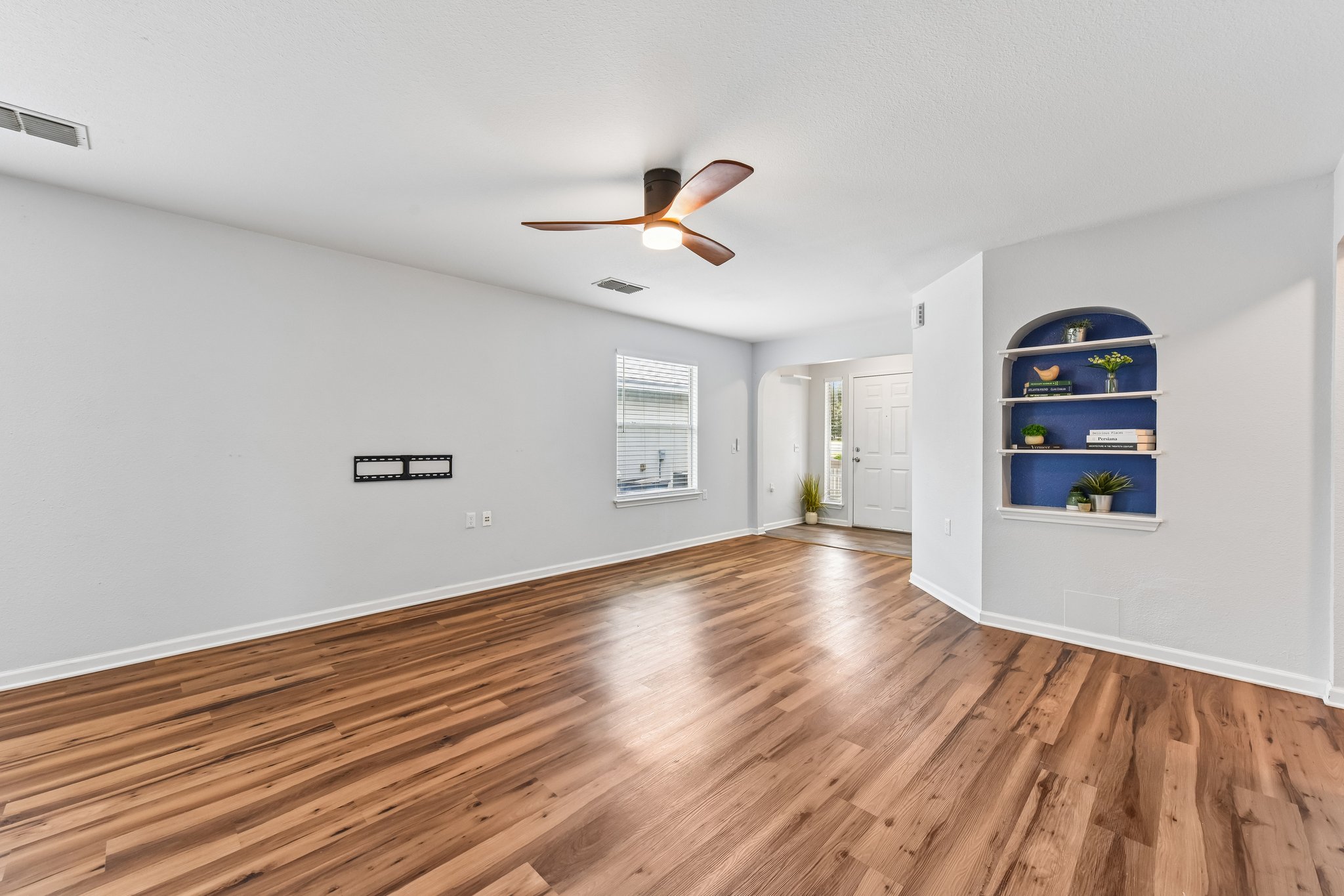 5405 Rusk Court Austin, TX 78723 - Photo 13 of 40 Natural light illuminates the living room and the stylish ceiling fan is a bonus to this welcoming space.