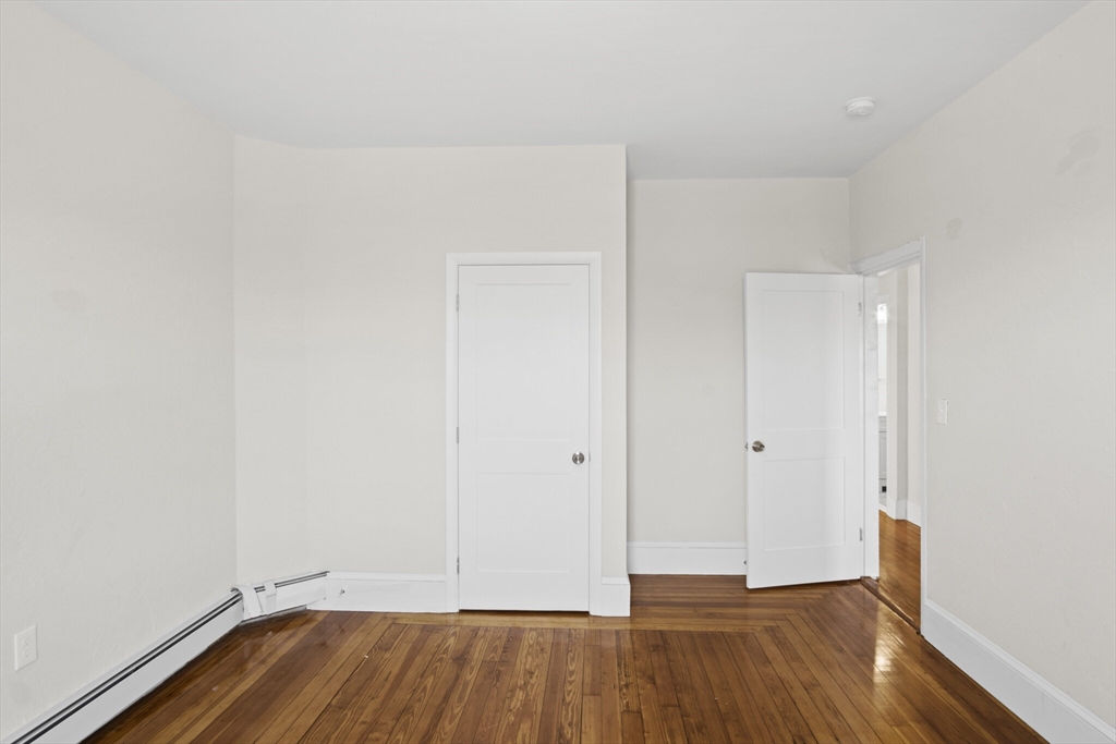 10 Redfield Street, Unit 2 Boston, MA 02122 - Photo 3 of 10 a view of room with wooden floor