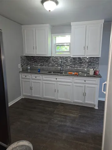 a kitchen with a sink and cabinets
