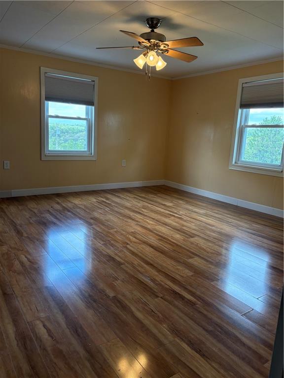9155 Maple Street Pittsburgh, PA 15239 - Photo 13 of 16 a view of an empty room with wooden floor and a window