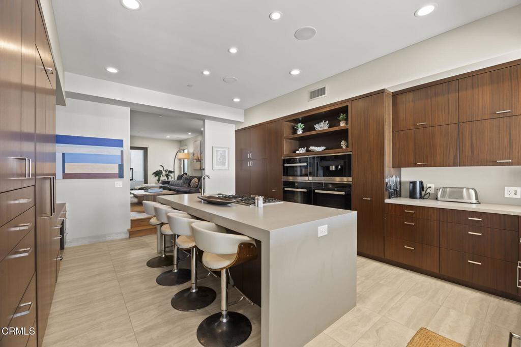 1409 Marine Way Oxnard, CA 93035 - Photo 11 of 58 a kitchen with a table chairs refrigerator and cabinets