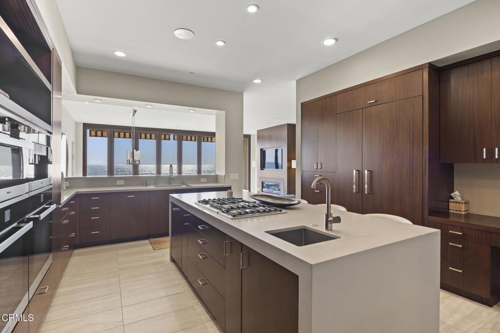 1409 Marine Way Oxnard, CA 93035 - Photo 12 of 58 a kitchen that has a sink a stove and lots of wooden cabinets