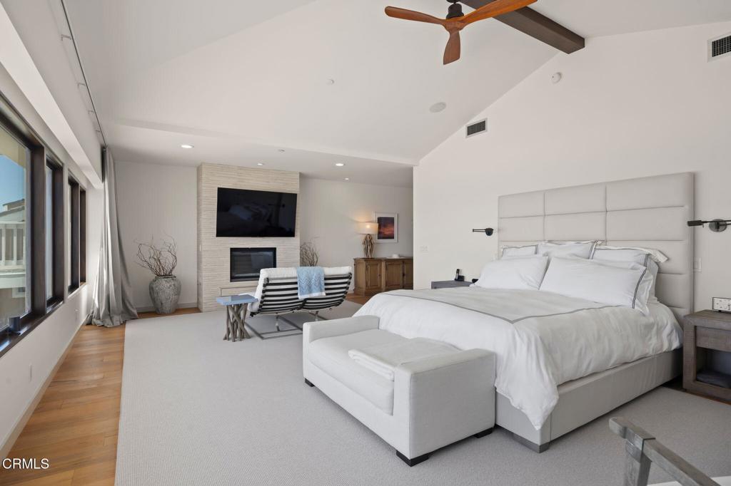 1409 Marine Way Oxnard, CA 93035 - Photo 35 of 58 a spacious bedroom with a bed a couch and a flat screen tv