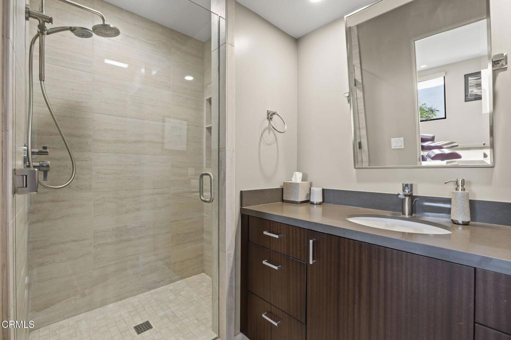 1409 Marine Way Oxnard, CA 93035 - Photo 47 of 58 a bathroom with a granite countertop sink a shower and a mirror