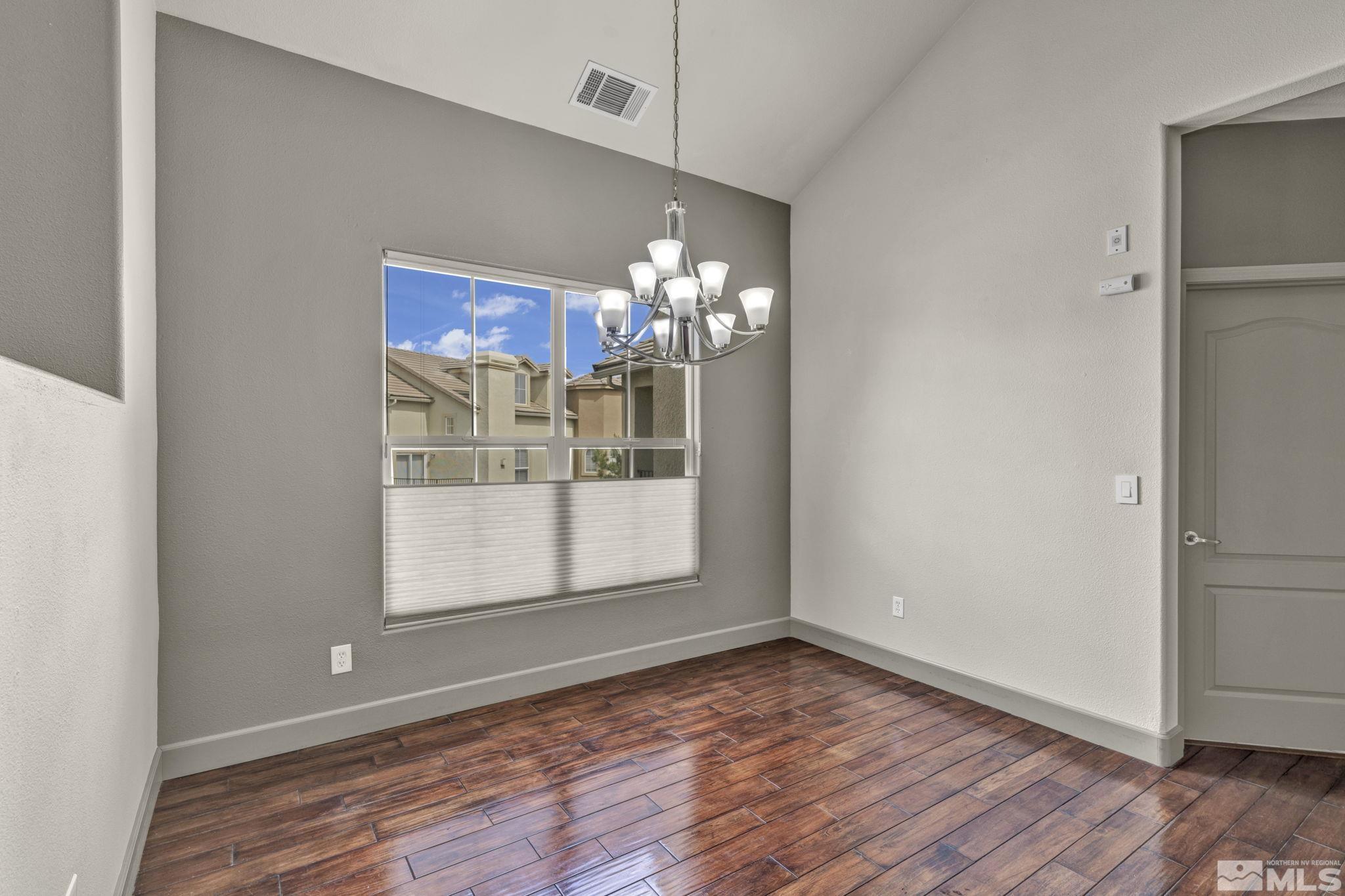 17000 Wedge Parkway, Unit 3422 Reno, NV 89511 - Photo 13 of 39 a view of a room with wooden floor and chandelier