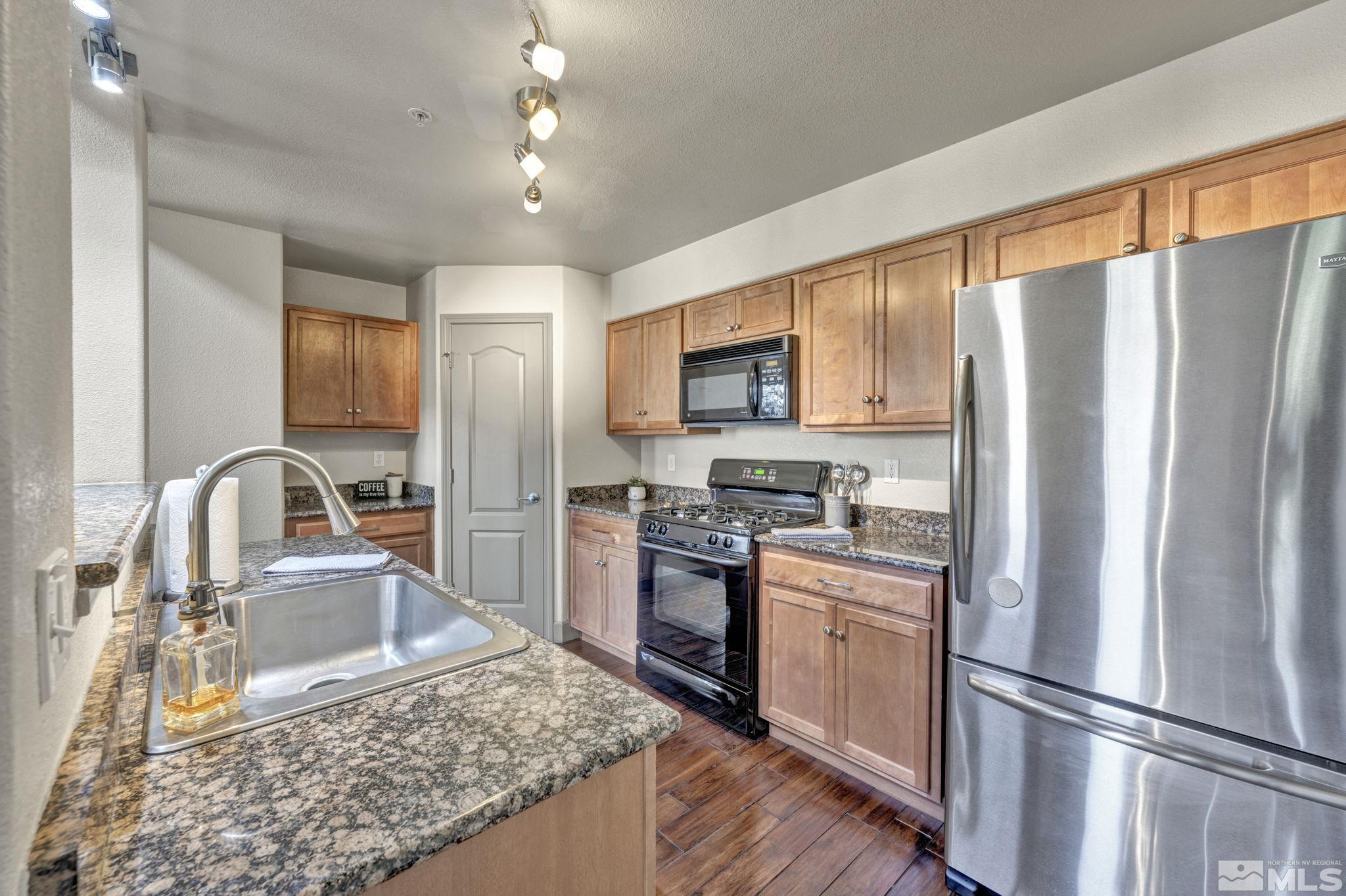 17000 Wedge Parkway, Unit 3422 Reno, NV 89511 - Photo 3 of 39 a kitchen with stainless steel appliances granite countertop a refrigerator stove top oven and sink