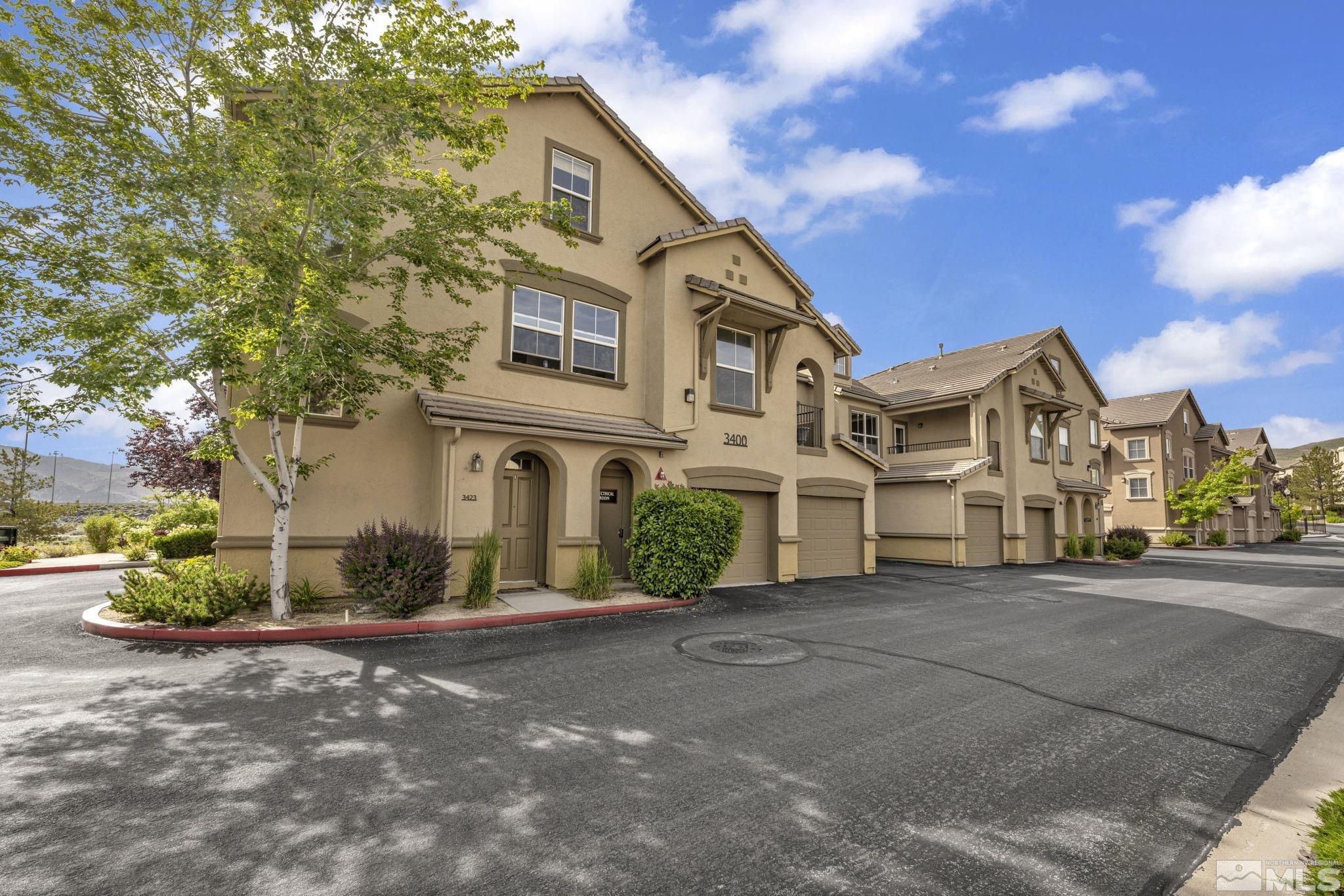 17000 Wedge Parkway, Unit 3422 Reno, NV 89511 - Photo 32 of 39 a front view of a house with a yard and garage