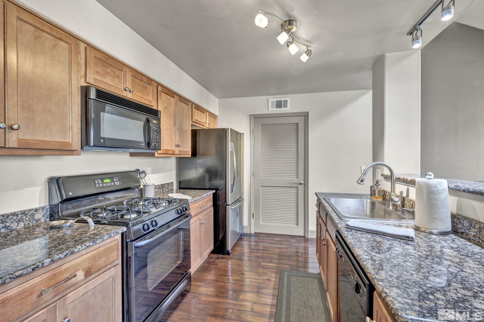 17000 Wedge Parkway, Unit 3422 Reno, NV 89511 - Photo 5 of 39 a kitchen with stainless steel appliances granite countertop a stove refrigerator and microwave
