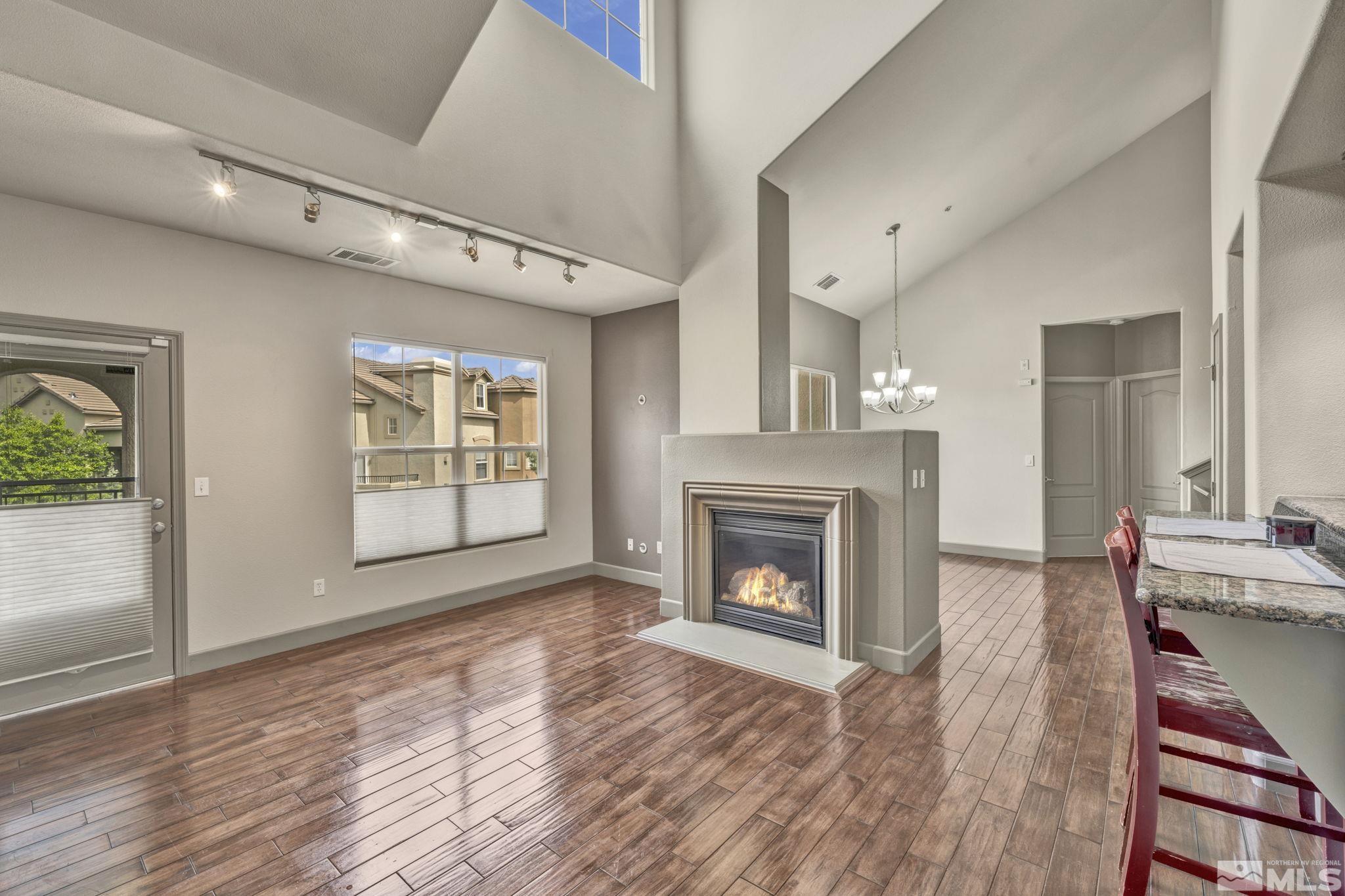 17000 Wedge Parkway, Unit 3422 Reno, NV 89511 - Photo 8 of 39 a view of an empty room with wooden floor fireplace and a window