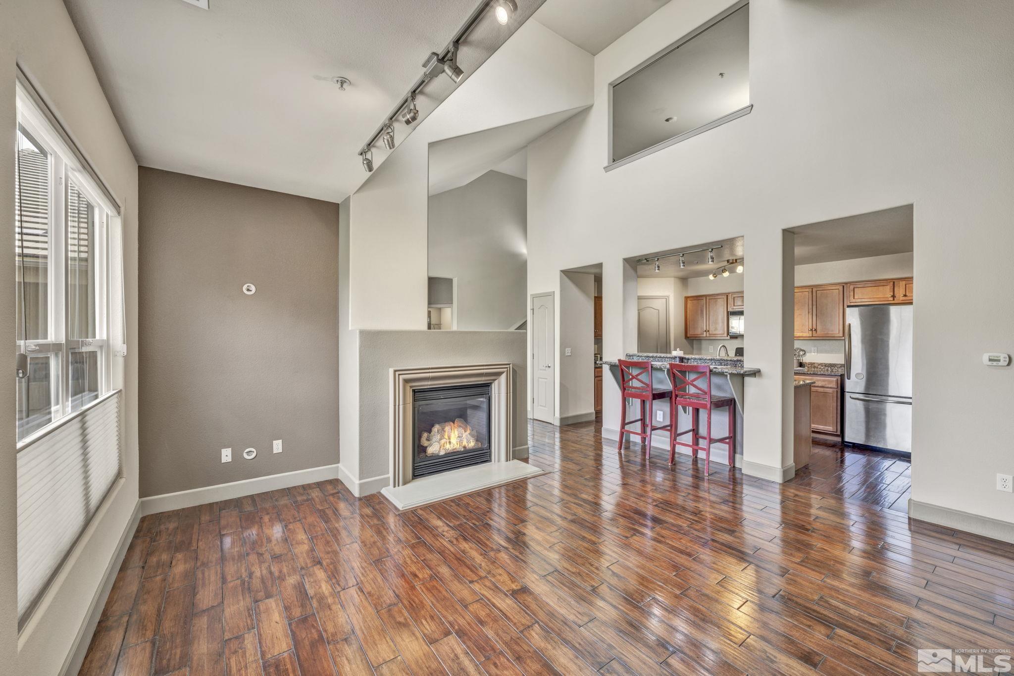17000 Wedge Parkway, Unit 3422 Reno, NV 89511 - Photo 9 of 39 a view of a livingroom with furniture a fireplace and wooden floor