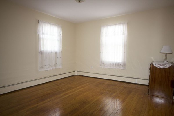1 Whitcomb Road East Providence, RI 02915 - Photo 6 of 9 an empty room with wooden floor and windows