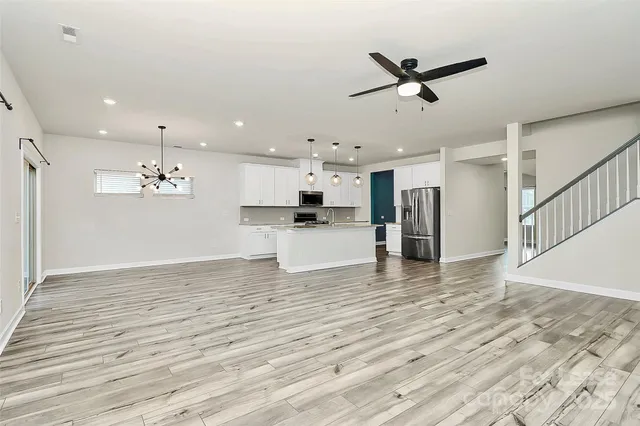 a view of a kitchen with a sink and a refrigerator