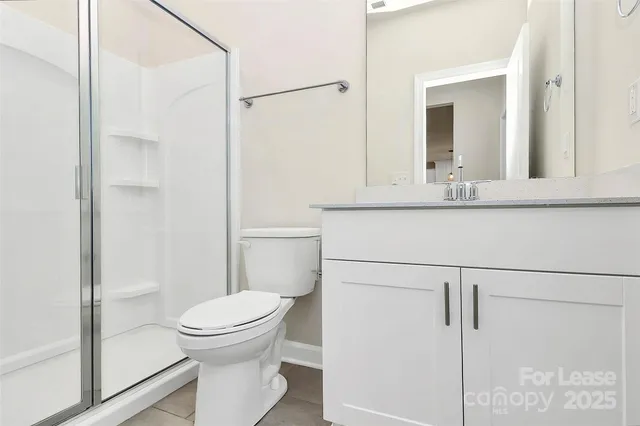 a bathroom with a toilet a sink and shower