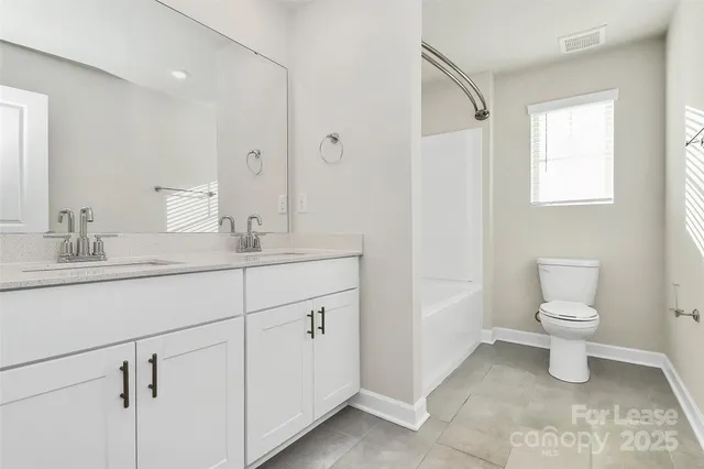 a bathroom with a sink toilet and vanity
