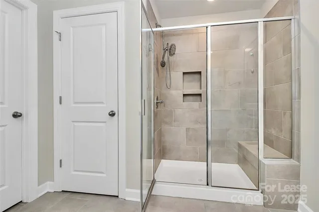 a bathroom with a glass shower door