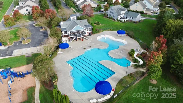 an aerial view of a swimming pool patio yard and outdoor seating