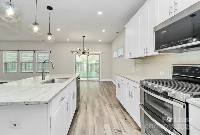a kitchen with a sink stove and microwave