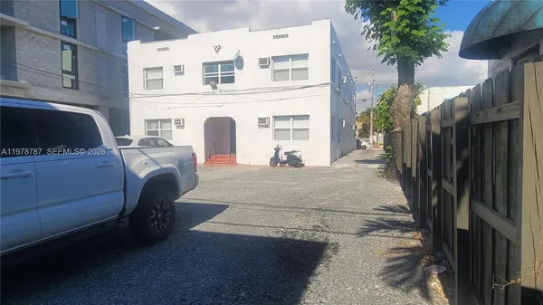a kitchen with a sink a window and cabinets
