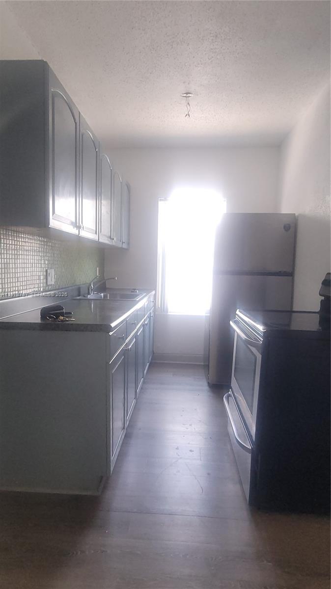 1322 Southwest 7th Street, Unit 4 Miami, FL 33135 - Photo 9 of 15 a kitchen with a sink a window and cabinets