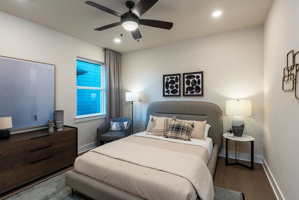 9504 Hamadryas Drive Austin, TX 78744 - Photo 11 of 23 a bedroom with a bed and a chandelier