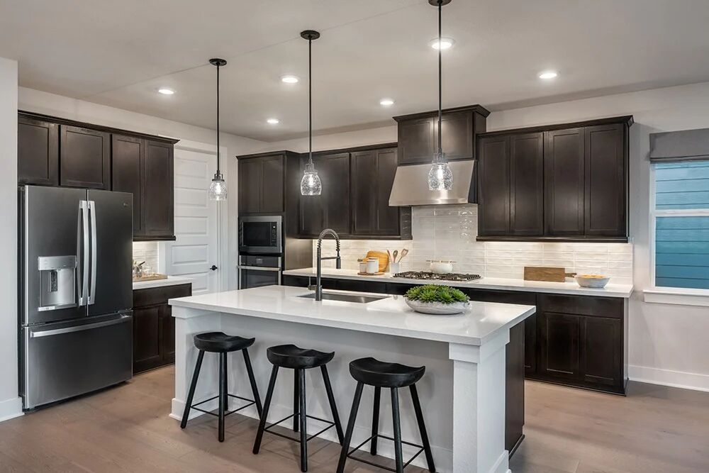 9504 Hamadryas Drive Austin, TX 78744 - Photo 4 of 23 a kitchen with stainless steel appliances kitchen island a sink and a refrigerator