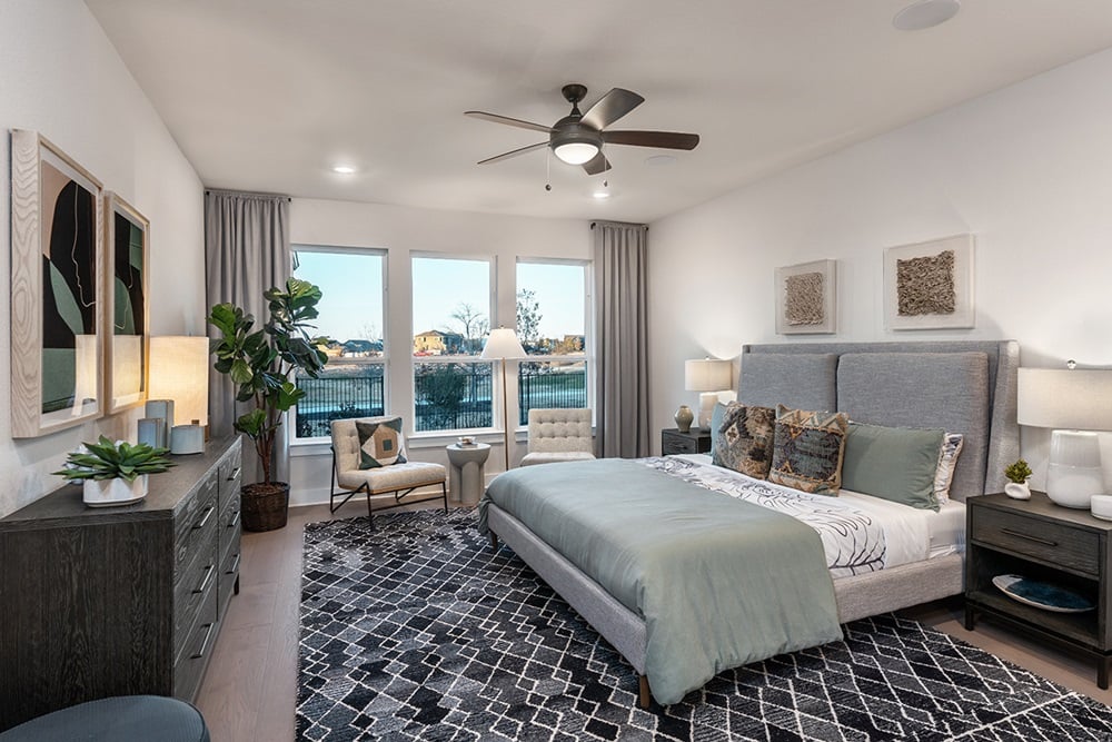 9504 Hamadryas Drive Austin, TX 78744 - Photo 9 of 23 a bedroom with a bed a couch and a potted plant