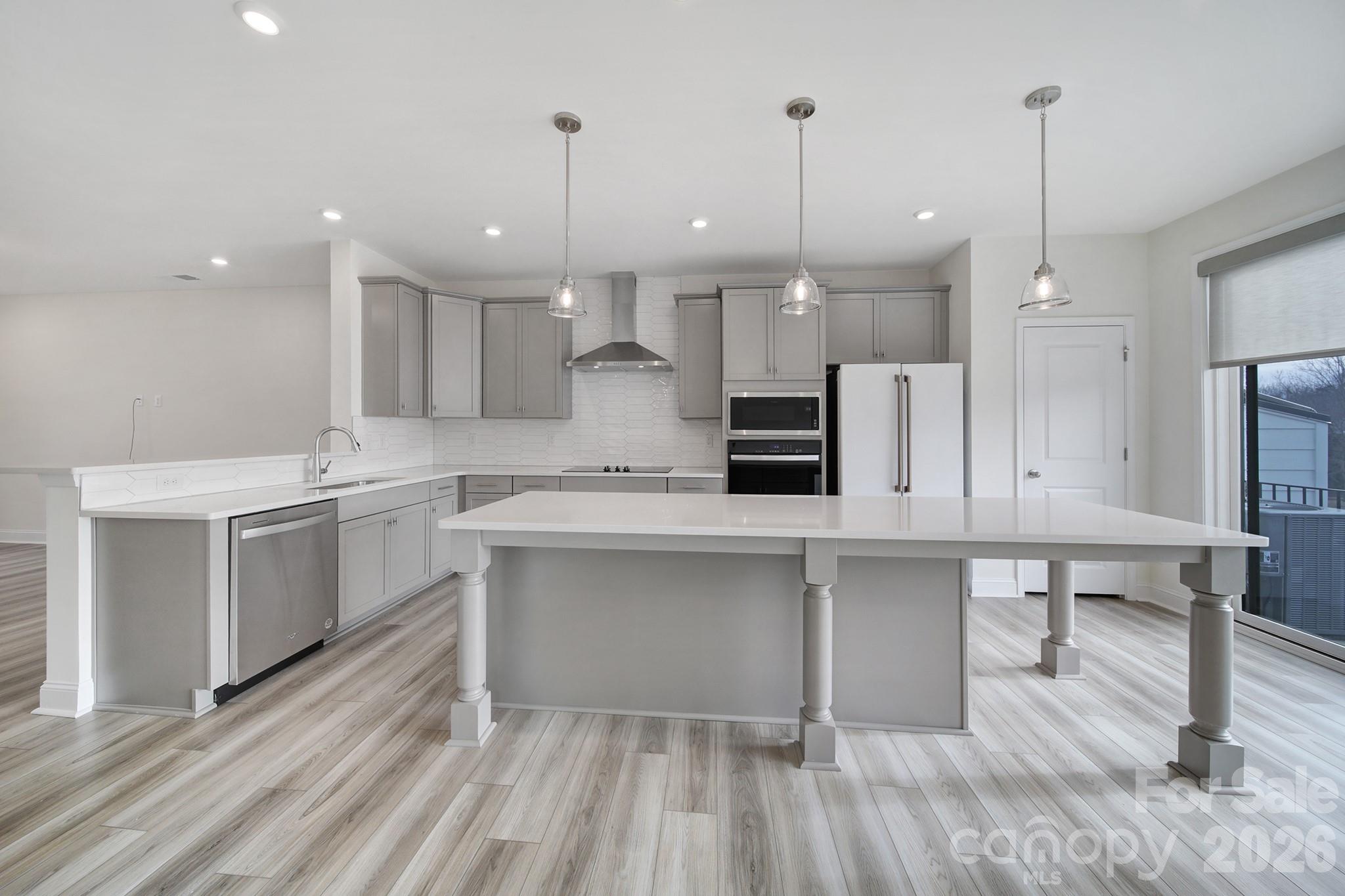 643 District Court Fort Mill, SC 29708 - Photo 12 of 41 a open kitchen with kitchen island a sink stainless steel appliances and white cabinets
