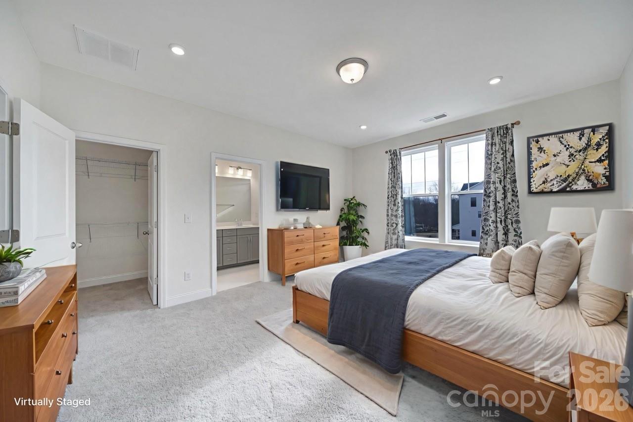 643 District Court Fort Mill, SC 29708 - Photo 21 of 41 a bedroom with a balcony a bed and a flat screen tv