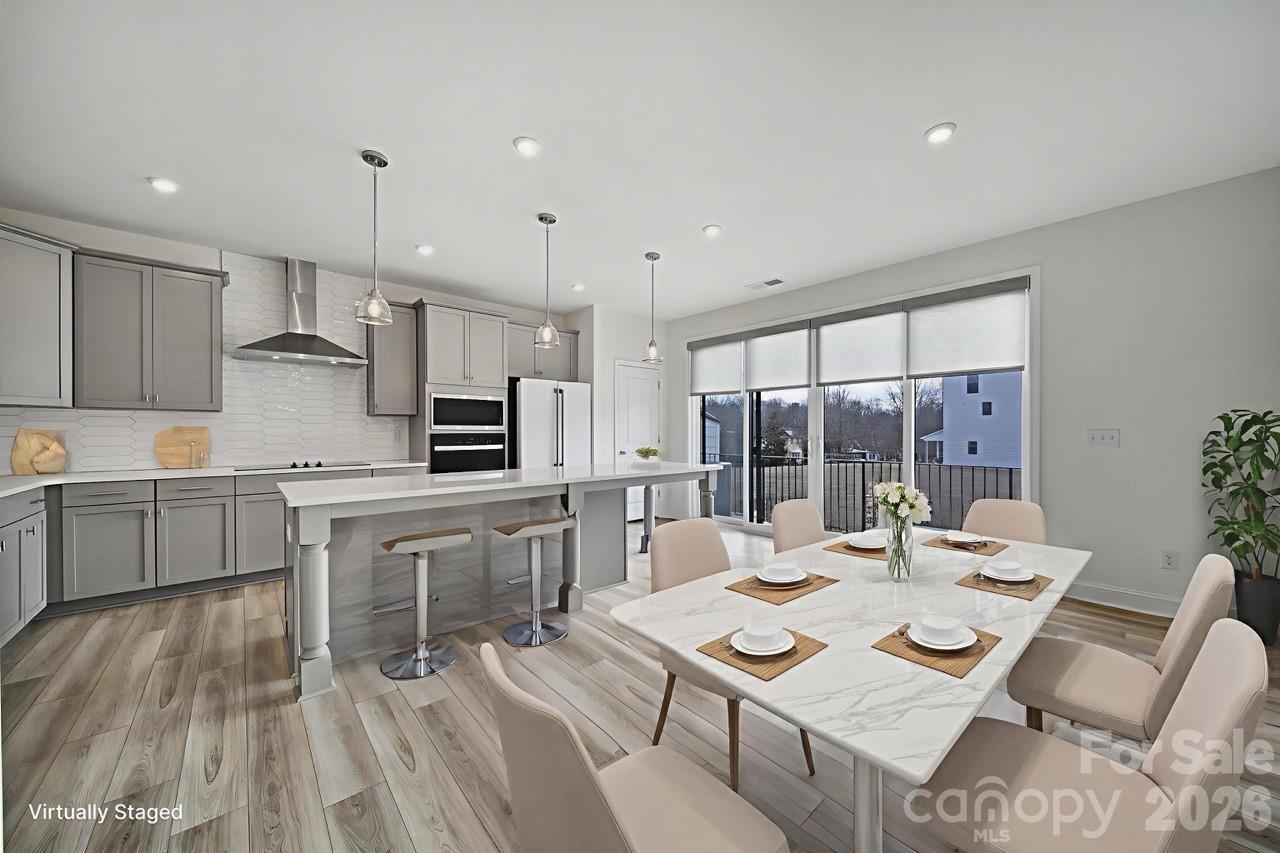 643 District Court Fort Mill, SC 29708 - Photo 10 of 41 a large kitchen with kitchen island a sink table and chairs