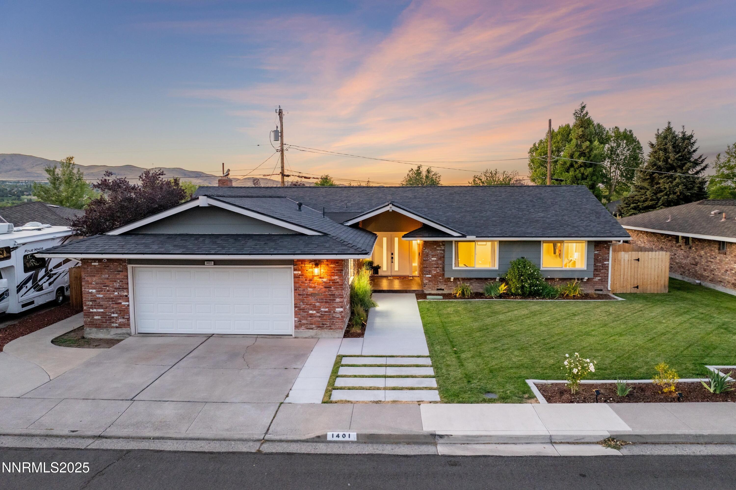 1401 Monroe Street Reno, NV 89509 - Photo 1 of 43 a front view of a house with a yard