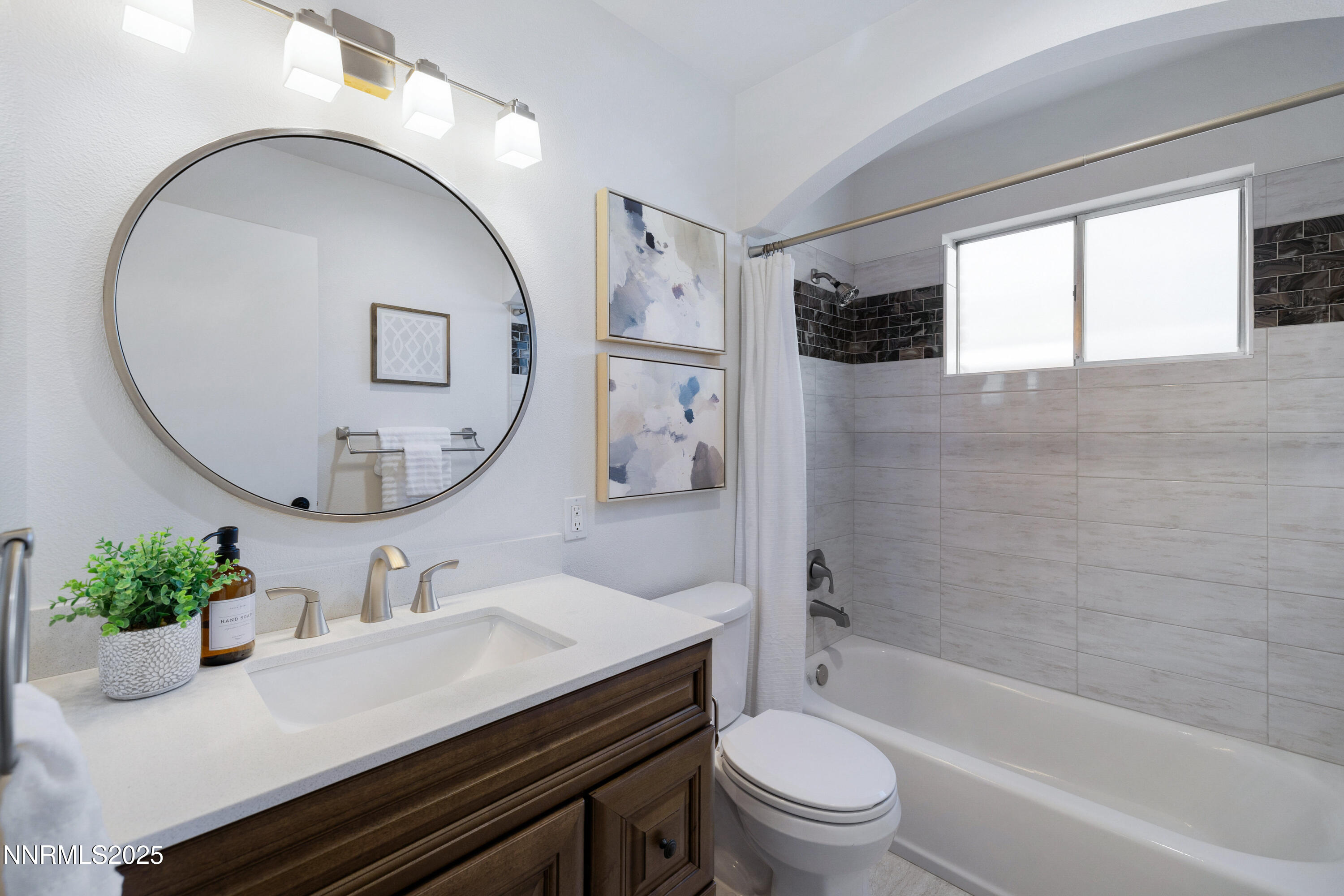 1401 Monroe Street Reno, NV 89509 - Photo 23 of 43 a bathroom with a sink a toilet and a mirror