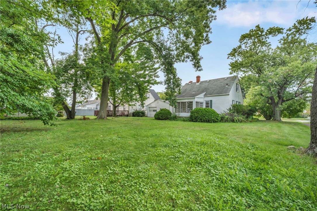 4250 Verona Road South Euclid, OH 44121 - Photo 30 of 31 Expansive lawn with mature trees, screened porch, and a detached garage