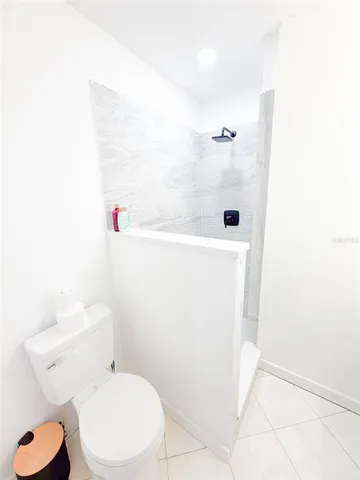 a white toilet sitting next to a white sink