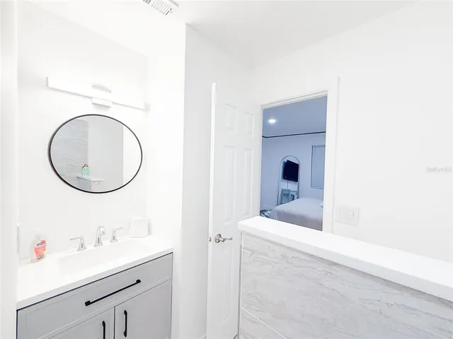 a bathroom with a sink a toilet and a mirror