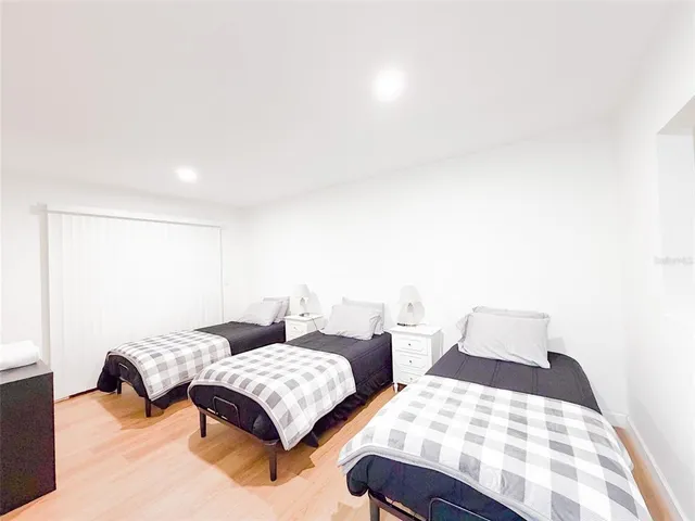 a bedroom with two beds and painting on the wall