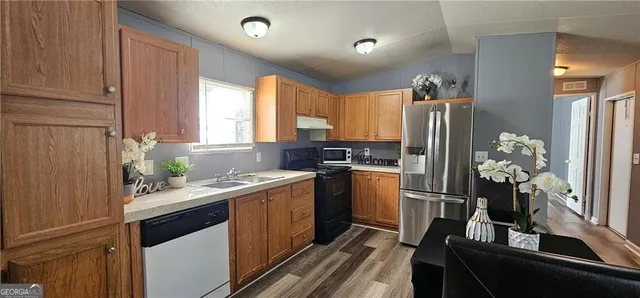 a kitchen with a sink stove and refrigerator