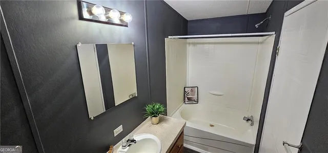 a bathroom with a sink and mirror